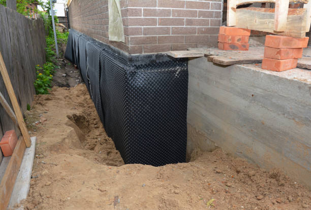 SJ Waterproofing Pros technician performing targeted Exterior Waterproofing assessment in Hemlock, IN